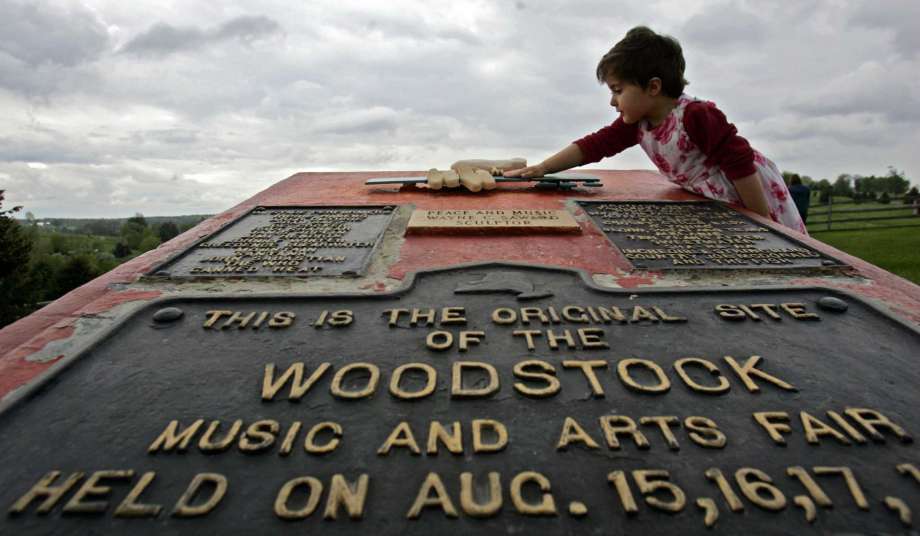 This May 15, 2008 file photo shows Emma Cenholt, 3, of Trumbull, Conn., playing on a memorial at the site of the Woodstock Music and Arts Fair in Bethel, N.Y. Connecticut Gov. Ned Lamont is bringing a Woodstock tribute concert to Woodstock, Conn., on Lanor Day weekend. Photo: Mike Groll / AP / 2008 AP